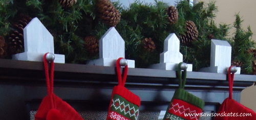 Four DIY stocking holders on a fireplace mantel
