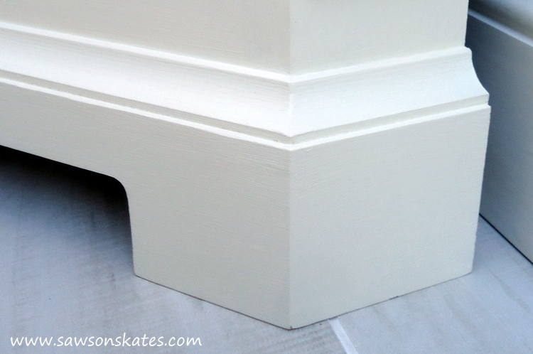 Looking for storage ideas? Build this small DIY corner cabinet! It's great for the bathroom or anywhere you need a little extra storage. It was inspired by a catalog retailer and it's loaded with molding detail.