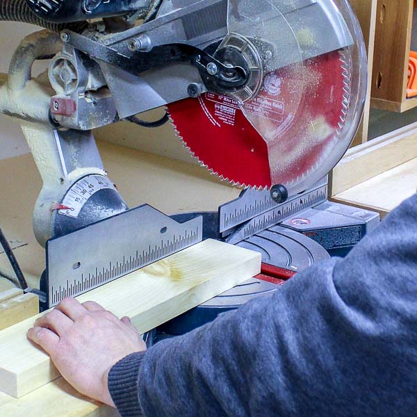 Cutting a piece of wood with a miter saw