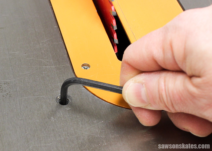 Loosen the 0-degree Adjustment Screw. The adjustment screw stops the blade at 0 degrees.