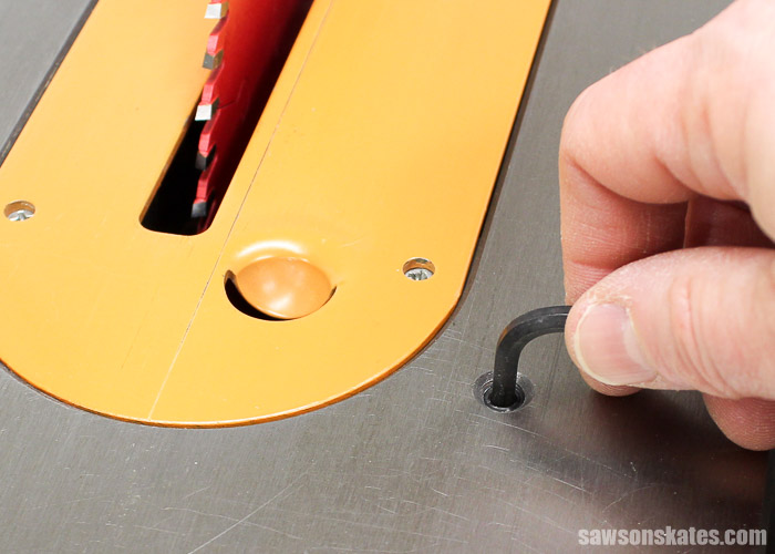 Loosen the 45-degree Adjustment Screw and Remove the Throat Plate. The adjustment screw stops the blade at 45 degrees. The throat plate will need to be removed in order to adjust the angle to 45 degrees.