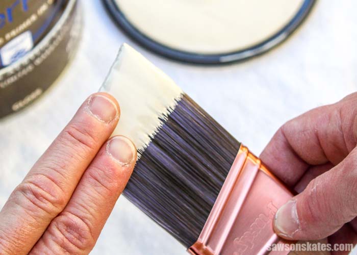 Loading the brush with about the width of two-and-half fingers helps to prevent getting paint in the ferrule. Keeping paint out of the ferrule makes the brush easier to clean.