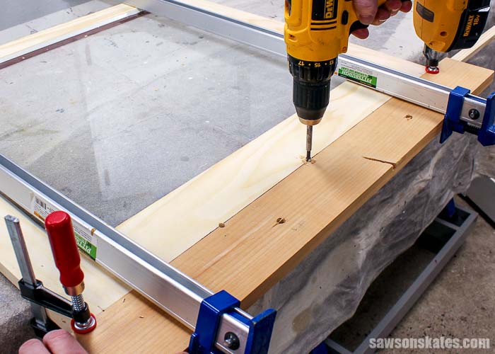 Weep holes are drilled in the bottom of DIY wood storm windows to allow water to escape