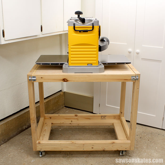 Front view of the flip top workbench in the open position with a tool mounted on top