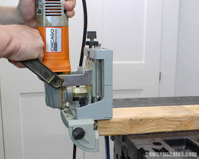 A biscuit joiner cutting a biscuit slot into the face of a workpiece