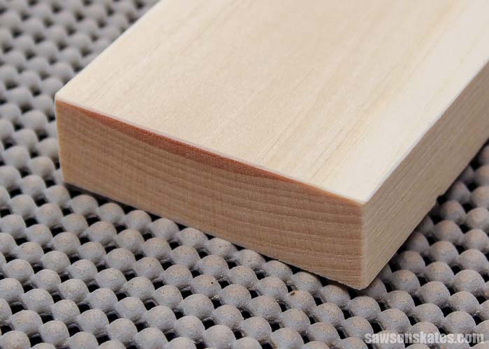 Using sandpaper to ease the edges of furniture projects prevents denting and gives the piece a finished look
