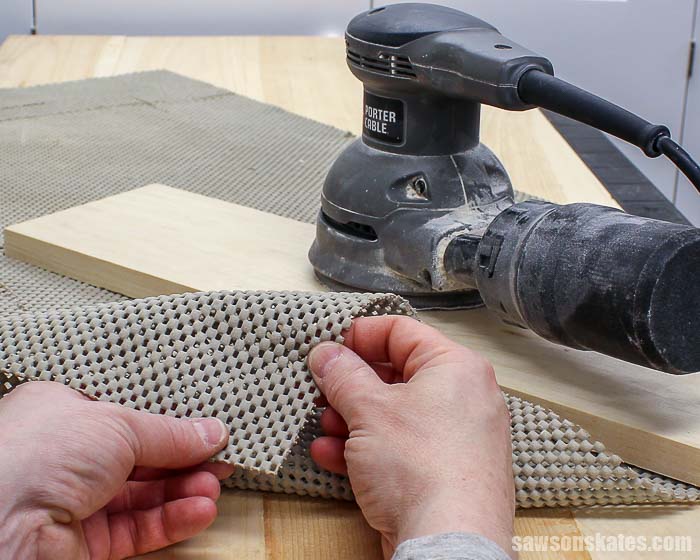 Sanding wood projects on a rubber router mat prevents parts from sliding