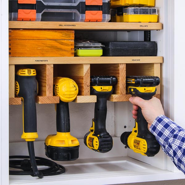 Hand placing a drill into a DIY holder