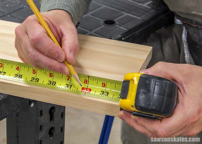 Measuring a board before making a cut with a DIY circular saw crosscut guide