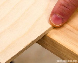 Placing a circular saw cutting guide on a pencil mark