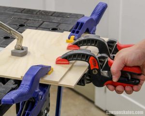 Clamping the fence on a circular saw cutting guide