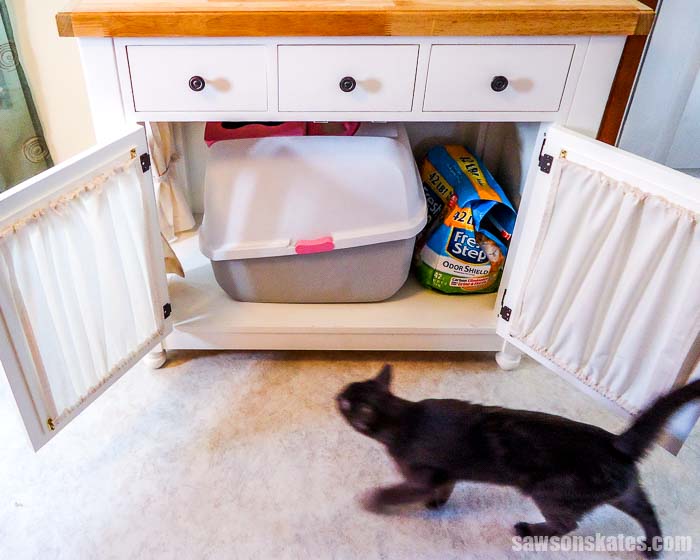 Kitty litter box furniture hides a litter box and has storage for extra litter