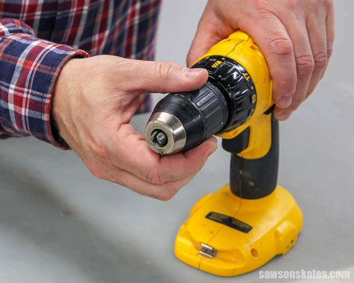 How to put a drill bit in a drill: hold the drill and open the jaws of the chuck