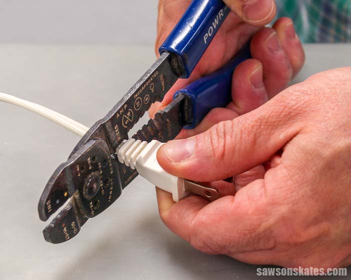 The first step to wiring a plug is to use wire strippers to cut off the broken plug