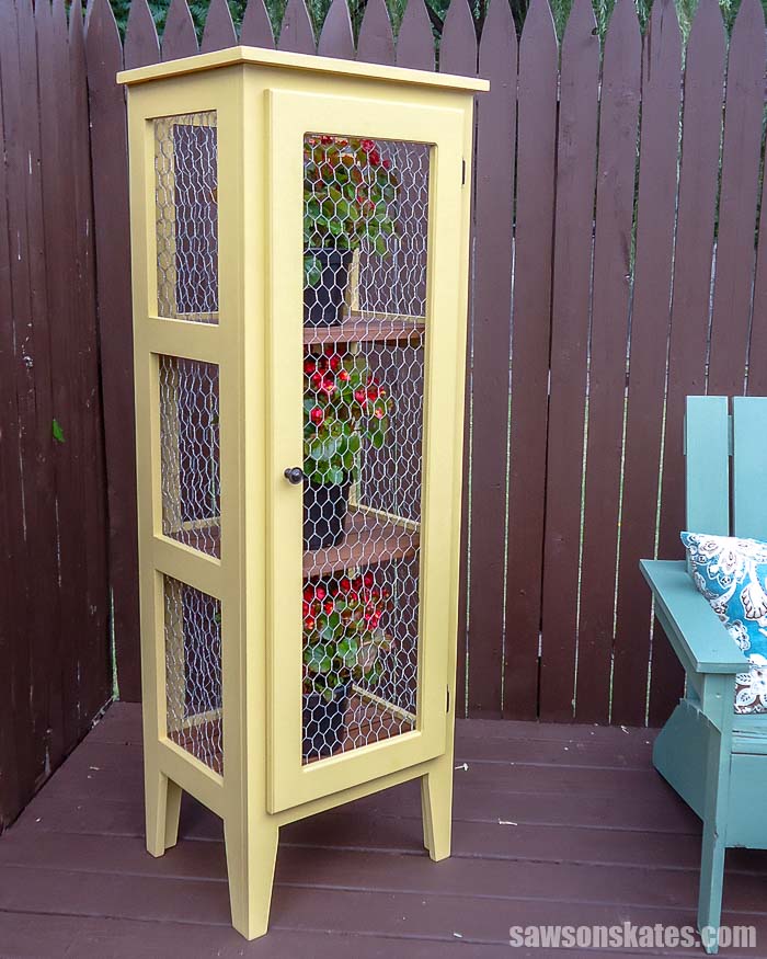 Get your Kreg Jig and make this creative DIY Outdoor Plant Stand! These patio cabinet plans show how to build a tiered wooden display for multiple plants!