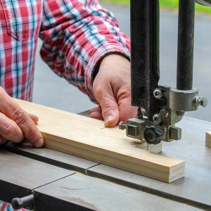 Cutting a window prop stick with a bandsaw