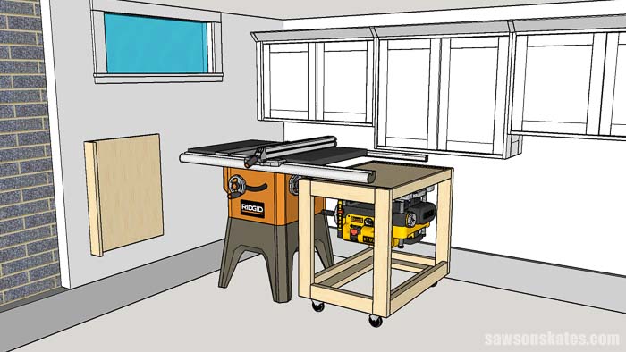 A flip top tool stand is stored under a table saw in this small woodshop layout