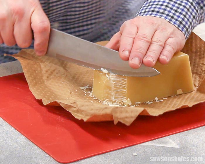 Cutting a block of beeswax that will be used to make a beeswax wood finish