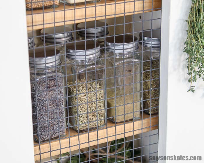 Spice jars lined up in an easy to build DIY spice rack