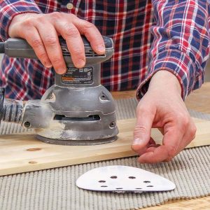 Reaching for a sanding disc that keeps flying off my orbital sander