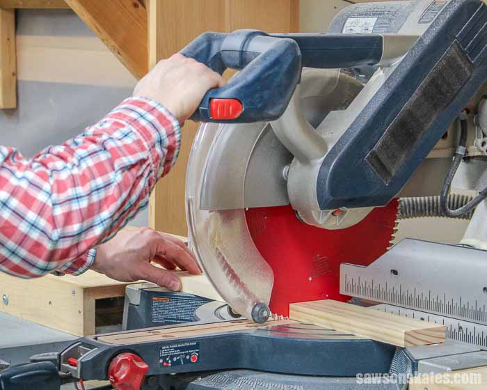 Cutting a piece of wood with a miter saw