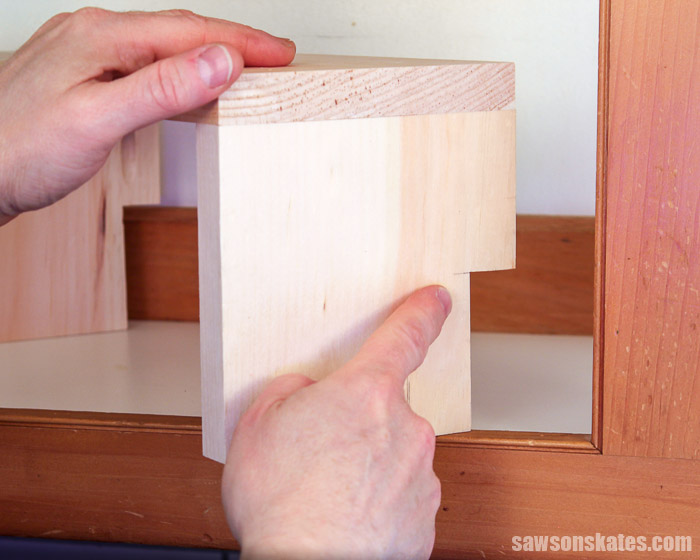 Showing a cutout at the back of a DIY cabinet organizer shelf