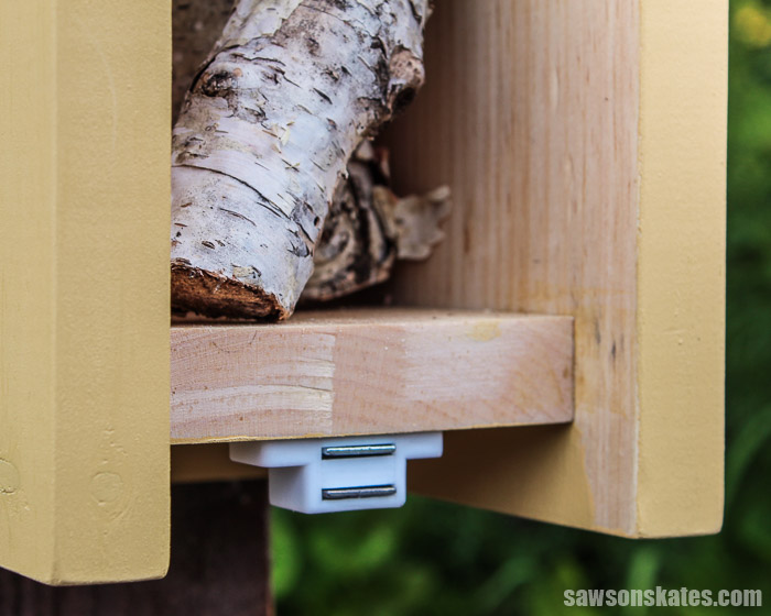 A magnetic catch keeps the door closed on this DIY butterfly house