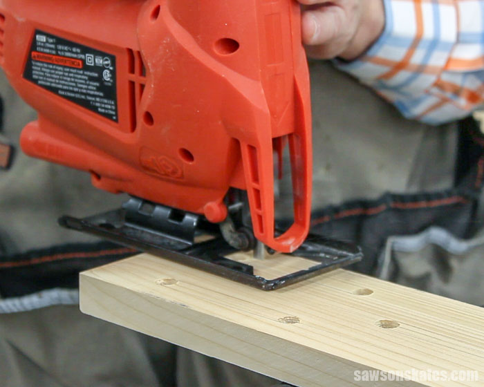 Using a jig saw to make the openings in a simple DIY butterfly house
