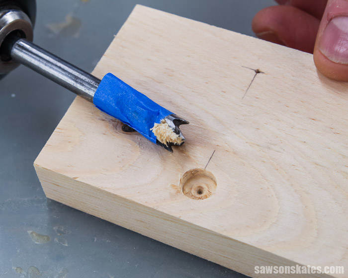 A Forstner bit used to drill a hole in a  wall-mounted DIY shelf bracket