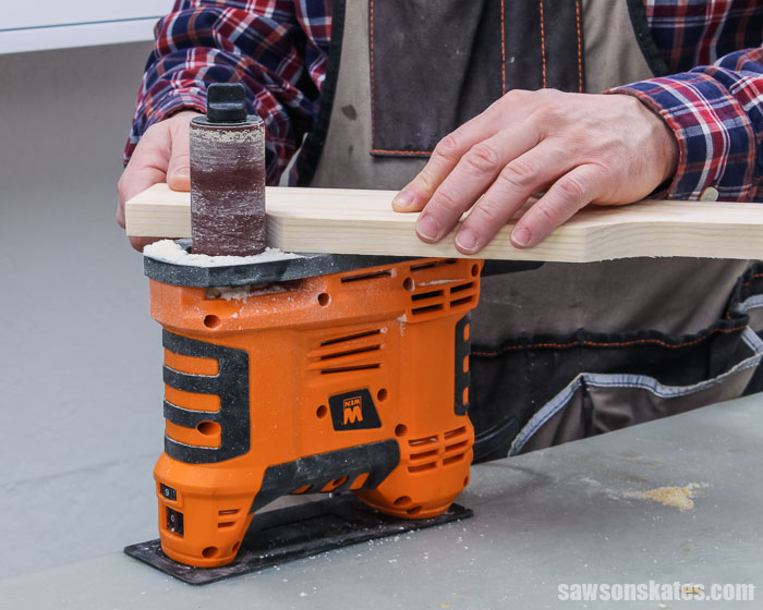 Using a spindle sander to smooth the curve detail for the top of a DIY spice shelf