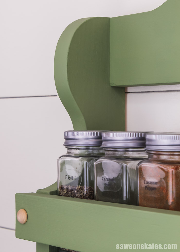 Three spice jars and a close up of the curved detail at the top of a DIY spice shelf