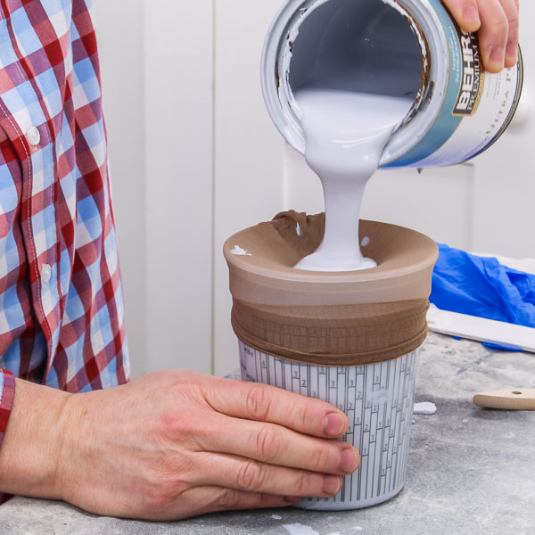 Pouring paint through a strainer