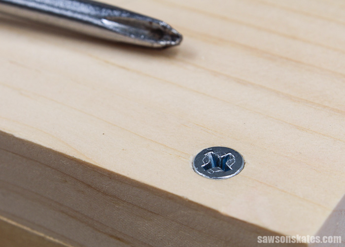 A screw flush with the surrounding wood because it's in a countersink hole