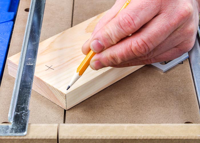 Positioning a board for a miter cut in a Kreg Crosscut Station