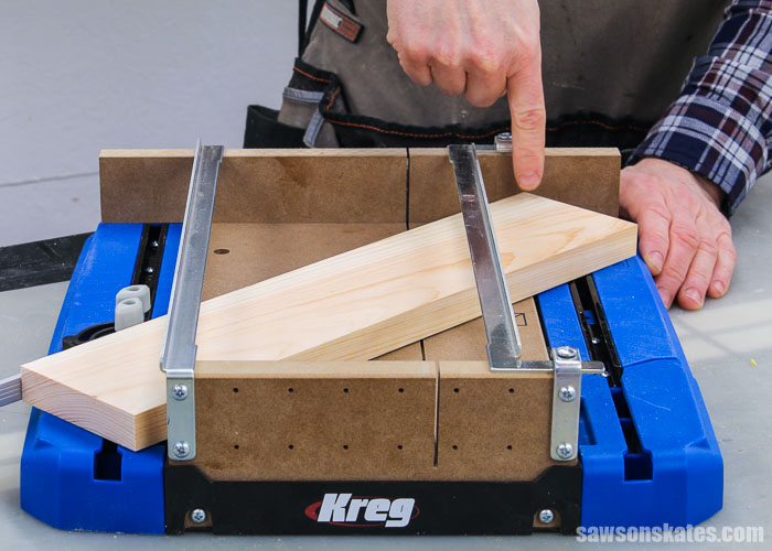 Finger pointing a board that is too long to make a miter cut in a Kreg Crosscut Station