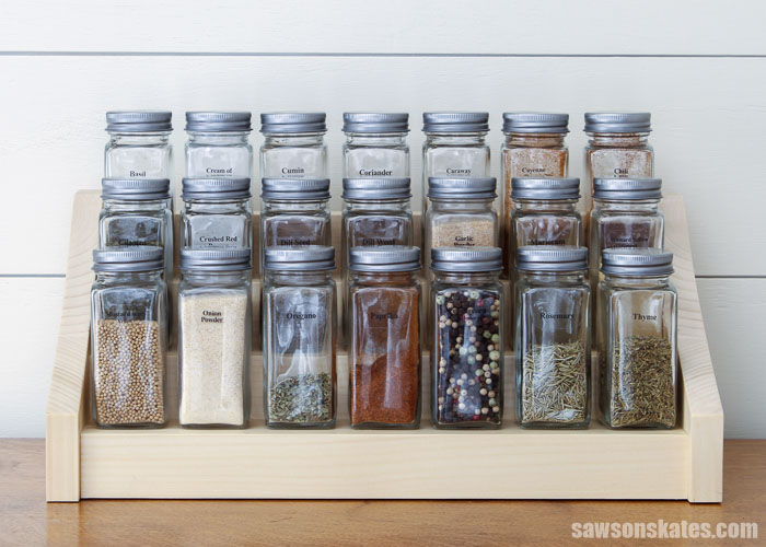 Front view of a DIY tiered spice rack with 21 spice jars