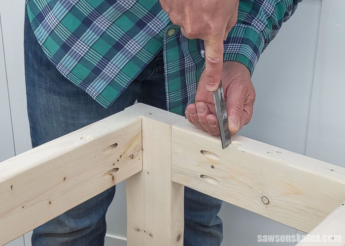 Using a chisel to square the openings for fasteners that will attach the top on a DIY power tool stand