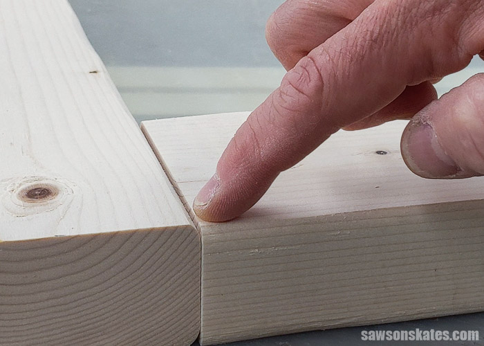 Showing the difference between the rounded edge of a 2×4 and the cut edge