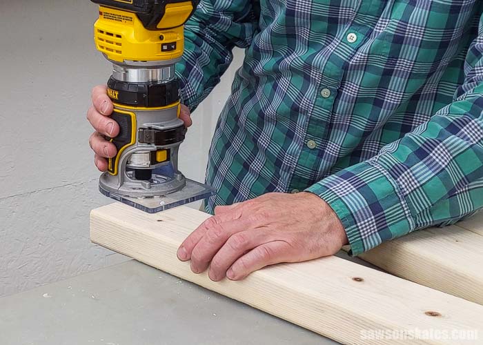 Using a router to round over the cut edges of a 2×4 used to make a DIY tool stand