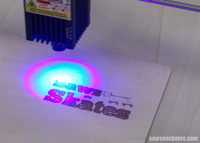 Ortur Laser Master 2 laser engraving a logo on a piece of wood