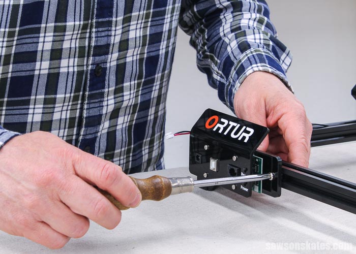 Using a screwdriver to attach the mainboard on an Ortur Laser Master 2