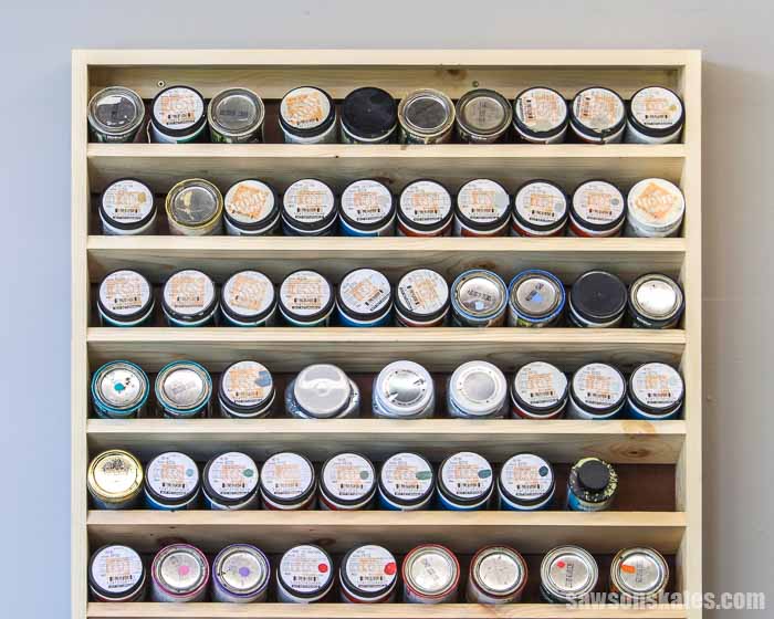 Front view of a DIY wall-mounted paint storage rack