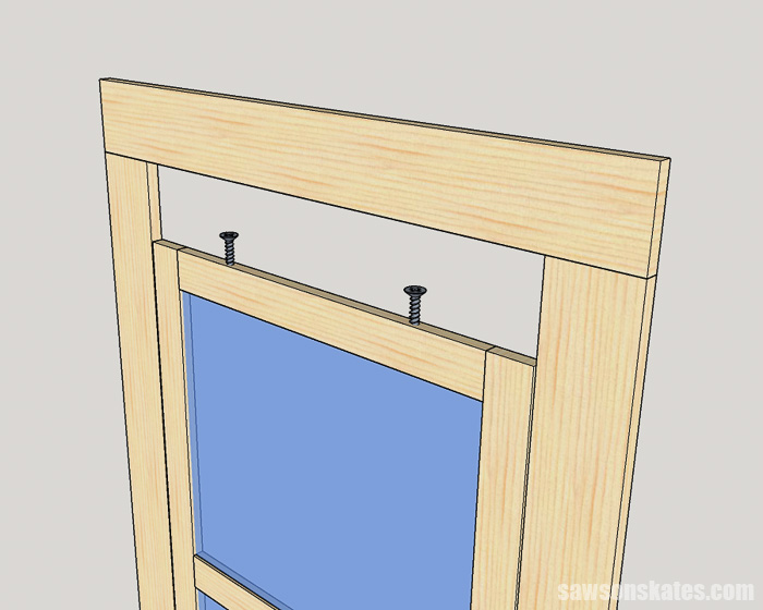 Sketch showing how a storm window is installed using screws that act as pins into holes in the exterior trim