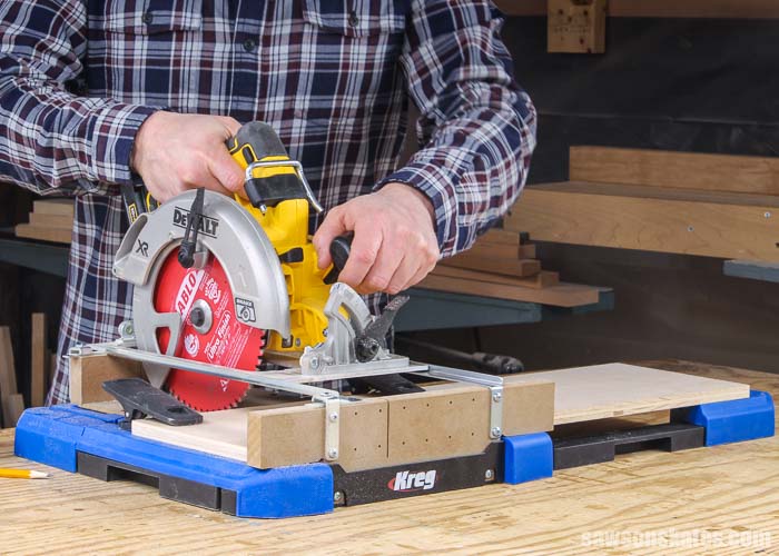 Using a circular saw and a Kreg Crosscut Station to cut a piece of plywood