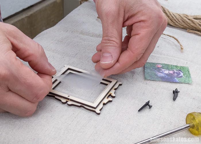 Placing clear plastic inside a DIY Christmas picture frame ornament