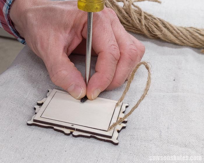 Attaching the turn buttons to the back of a DIY Christmas photo frame ornament