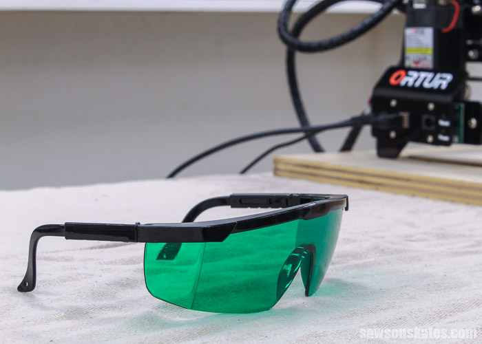 Safety glasses used to protect eyes while cutting a DIY Christmas picture frame ornament with a laser engraver