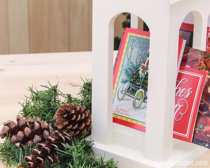 Front of a DIY Christmas card holder shaped like a church with cards inside