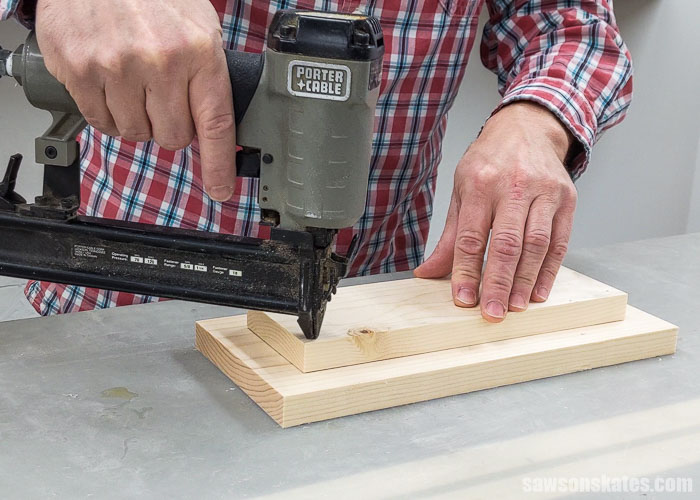 Using a brad nailer to attach the bottom of a DIY holiday card display