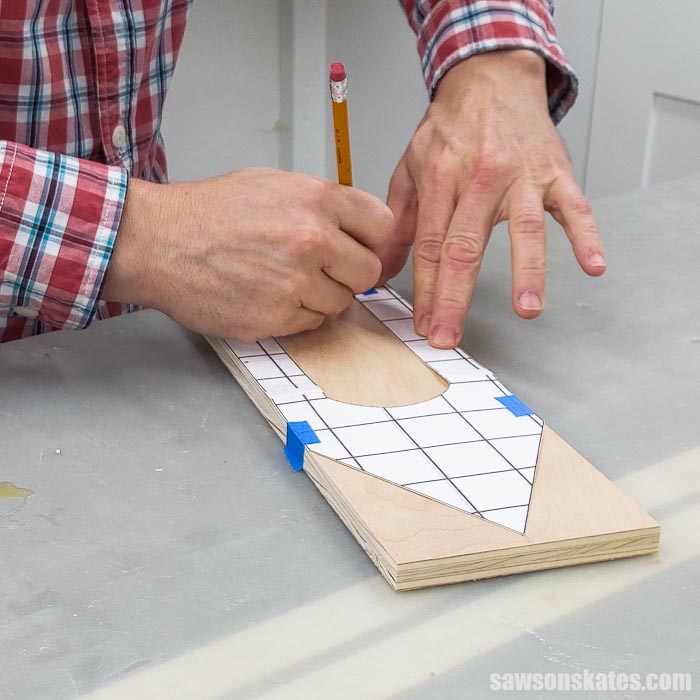 Tracing a template on a piece of wood for a DIY holiday card display